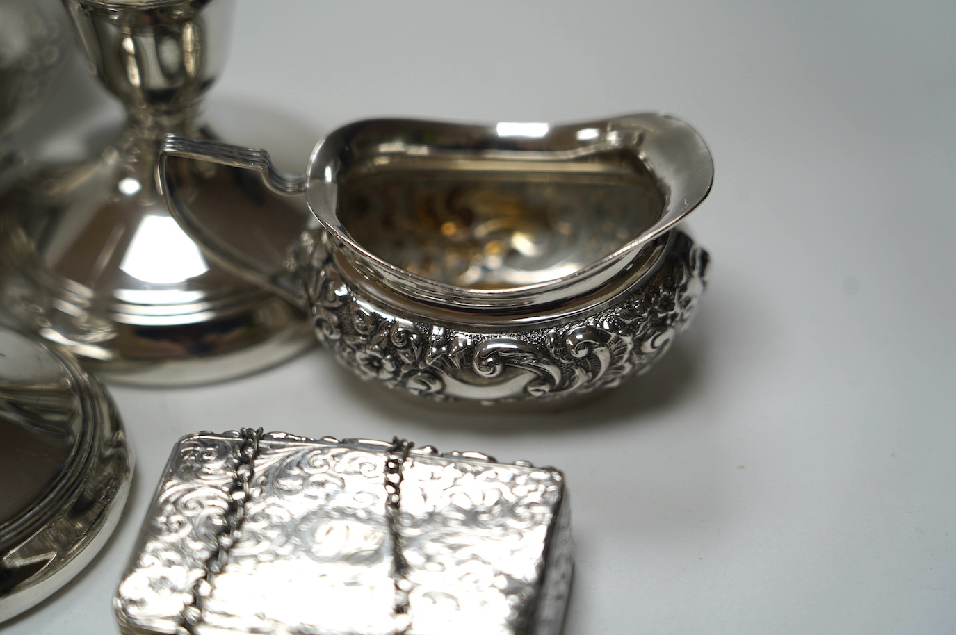 A group of mixed silver including a five bar toastrack, pair of dwarf candlesticks, 19th century snuff box, ring tree dish, cream jug, etc. Condition - poor to fair